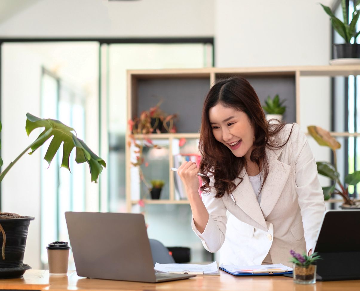 woman excited in her home office
