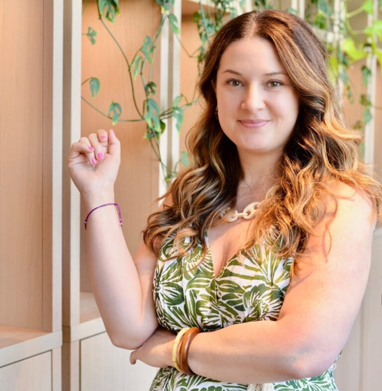 Marybeth Welty in green and white dress in beautiful office